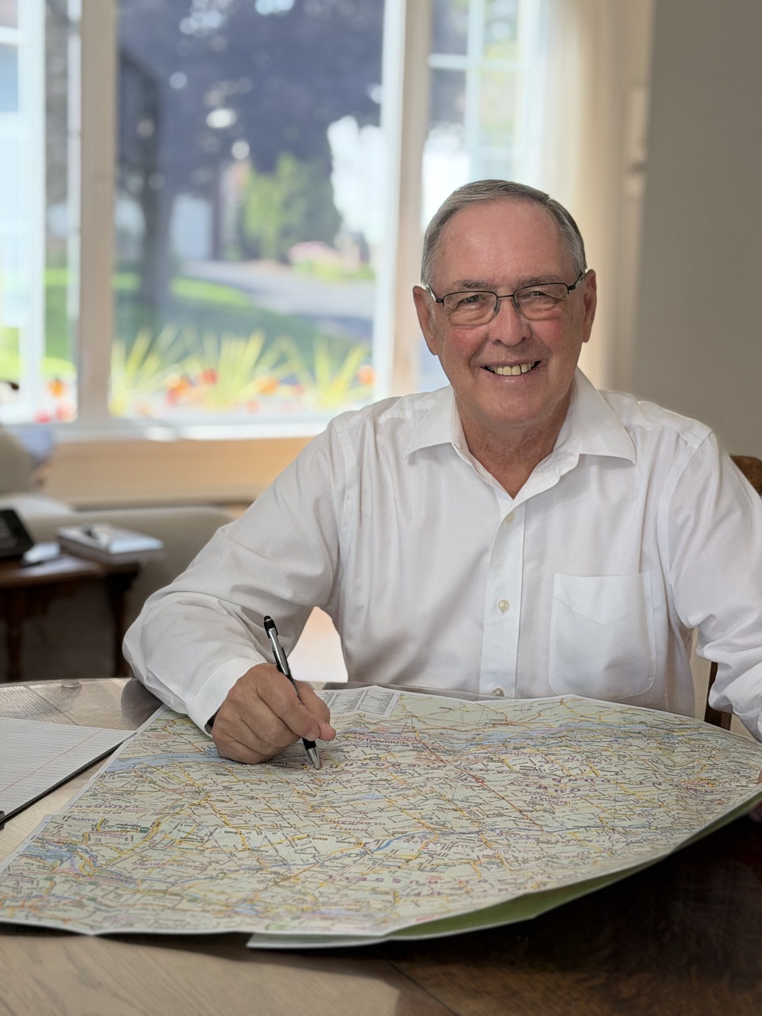 Keith MacCuaig reviewing notes and a map at a table